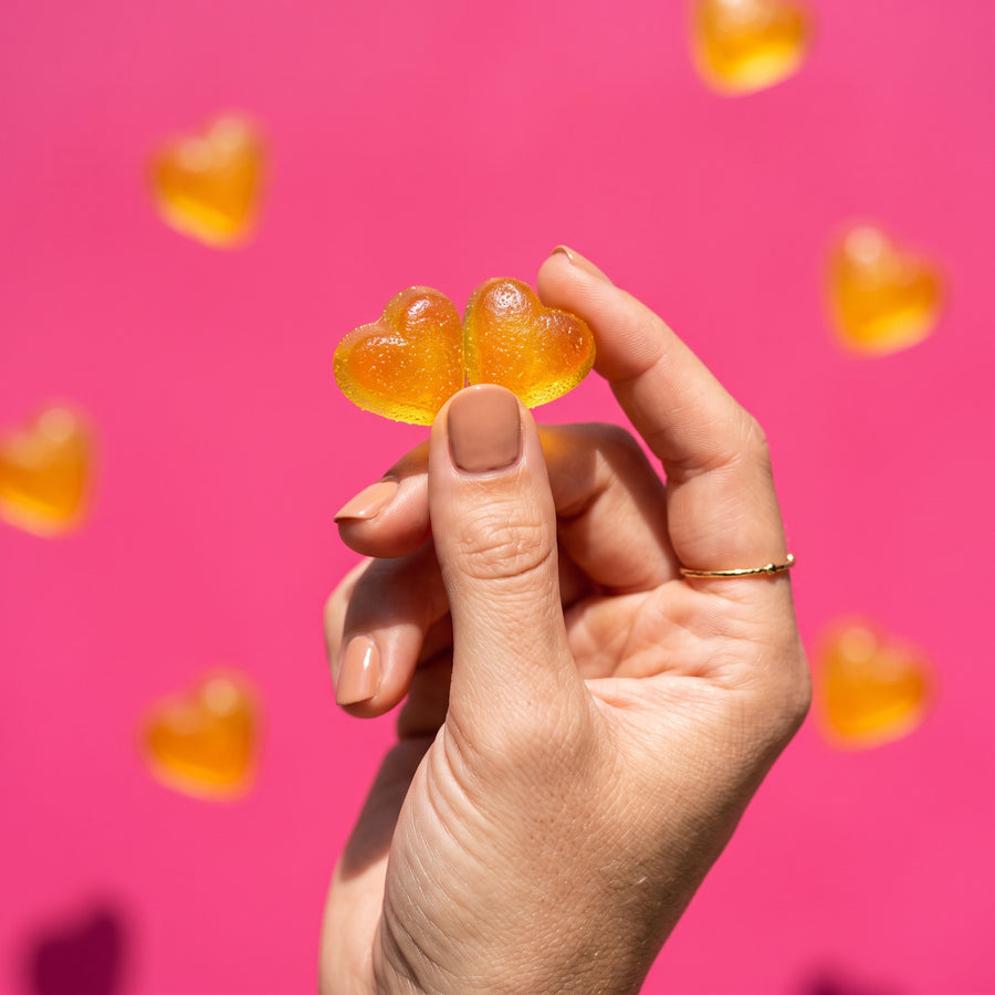 two golden heart gummies, offered